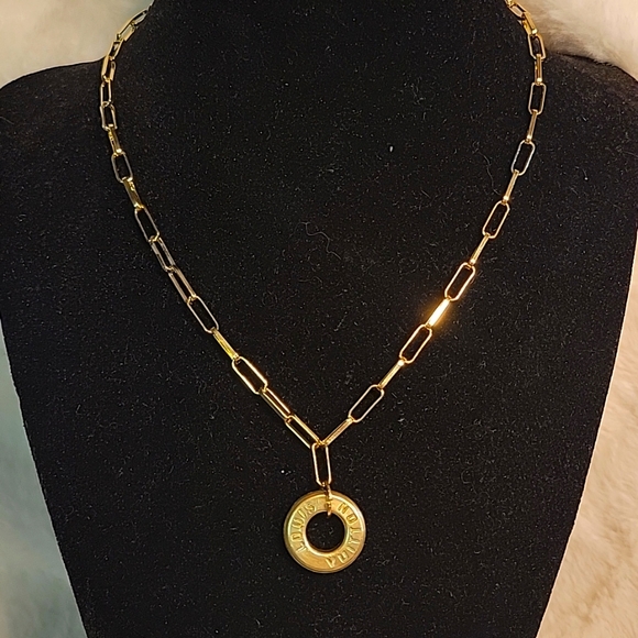 Louis Vuitton Jewelry - Authentic Louis Vuitton brass grommet circle Charm on a necklace